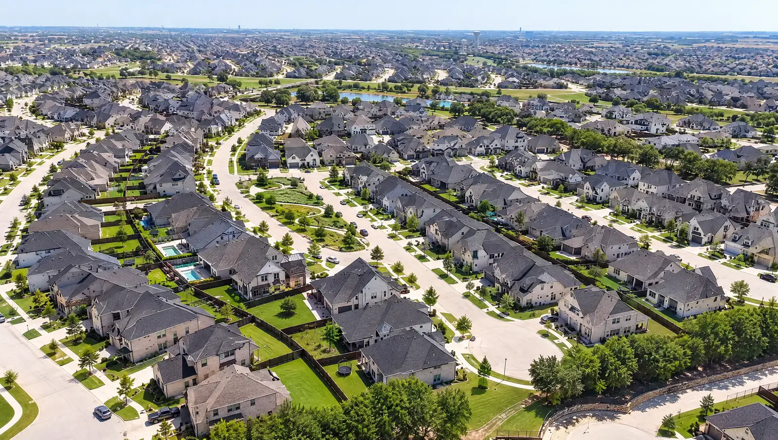 Aerial view of residential streets and tree-lined lots